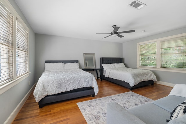 bedroom with wood-type flooring and ceiling fan