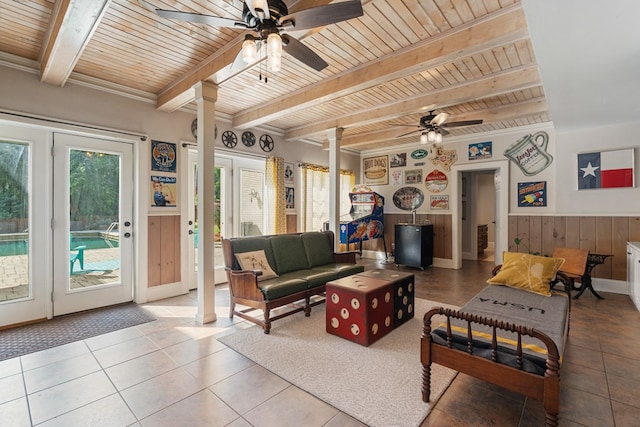 living room with wooden ceiling, tile patterned floors, wooden walls, beam ceiling, and decorative columns