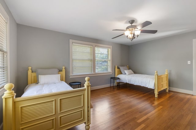 bedroom featuring ceiling fan and dark hardwood / wood-style floors