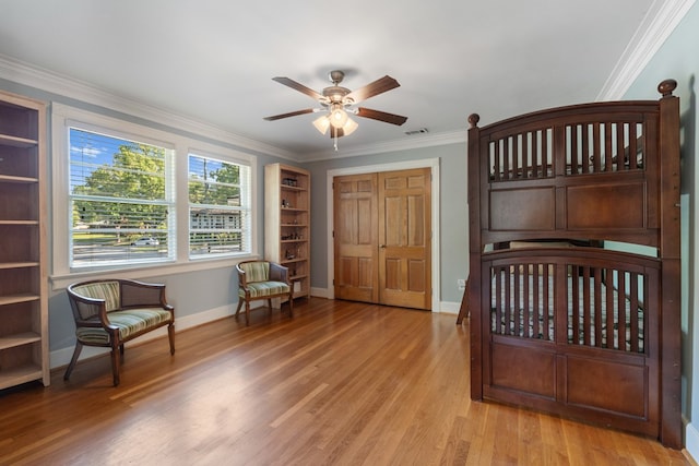 bedroom featuring ceiling fan, a closet, light hardwood / wood-style flooring, and ornamental molding