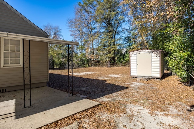 view of yard featuring a storage unit and a patio