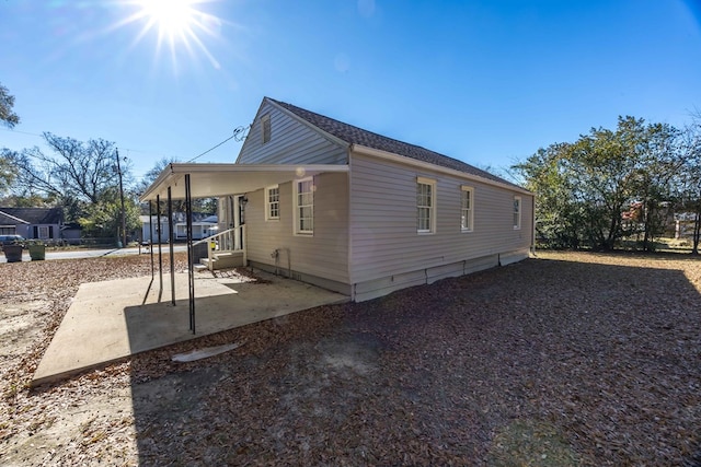 view of property exterior with a patio