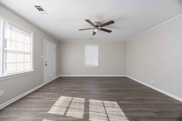 empty room with dark hardwood / wood-style floors, ceiling fan, and crown molding