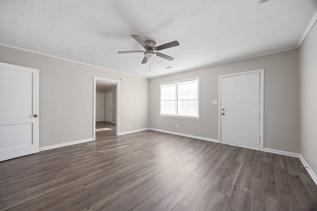 empty room with ornamental molding, a textured ceiling, ceiling fan, and dark wood-type flooring