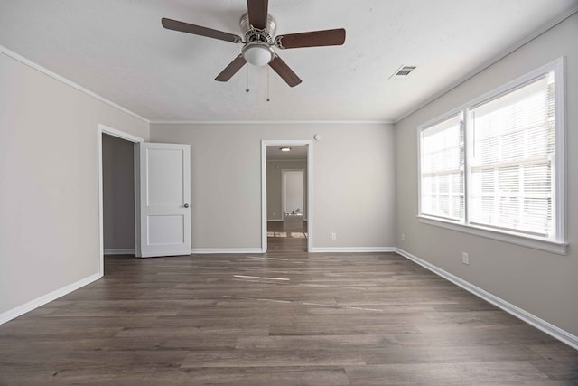 unfurnished bedroom with dark hardwood / wood-style floors, ceiling fan, and crown molding