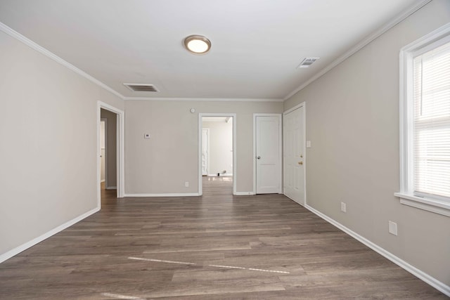 spare room featuring dark hardwood / wood-style flooring and ornamental molding