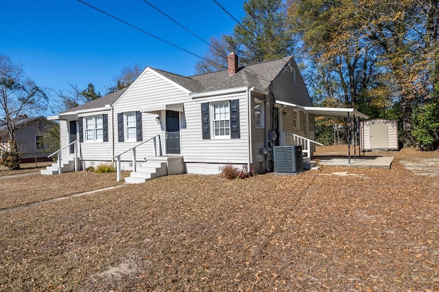 bungalow featuring central AC and a storage shed