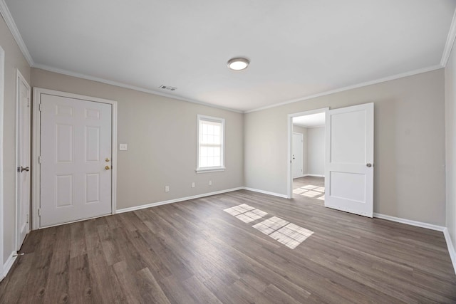 empty room featuring dark hardwood / wood-style flooring and ornamental molding