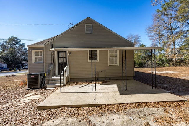 rear view of house with central AC