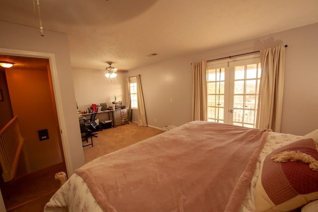 bedroom featuring french doors, light colored carpet, visible vents, a ceiling fan, and access to outside