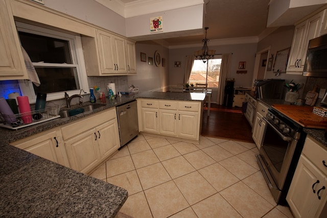 kitchen with light tile patterned floors, appliances with stainless steel finishes, ornamental molding, a sink, and a peninsula