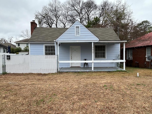 bungalow-style home featuring a porch and a front lawn