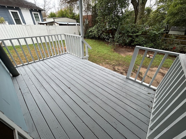 wooden terrace featuring a lawn