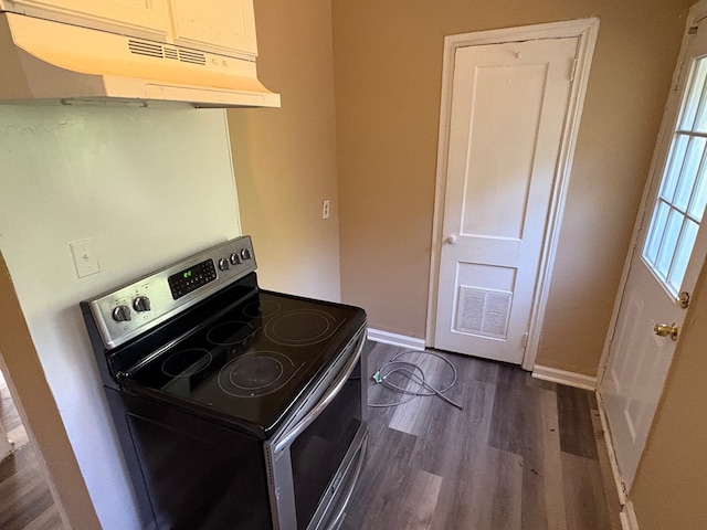 kitchen featuring stainless steel range with electric cooktop and dark hardwood / wood-style floors