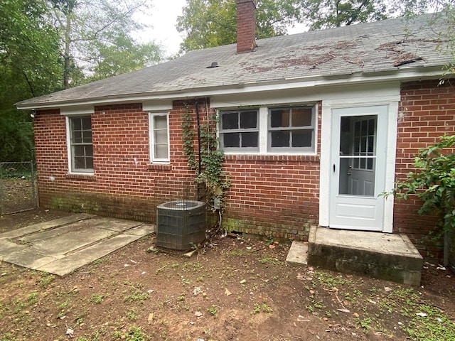 rear view of property with cooling unit