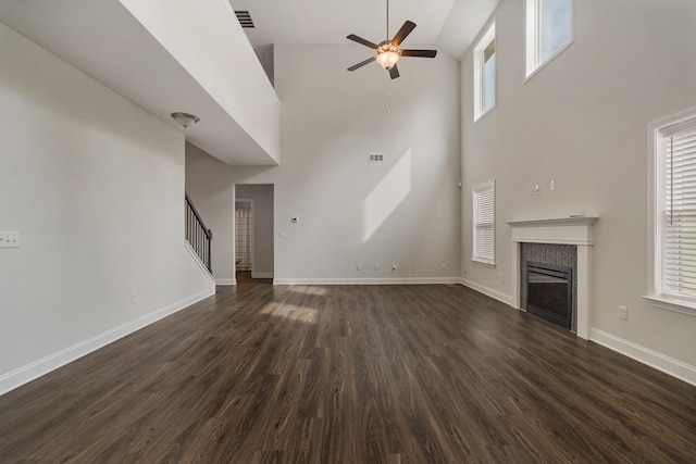 unfurnished living room with ceiling fan, high vaulted ceiling, and dark hardwood / wood-style floors