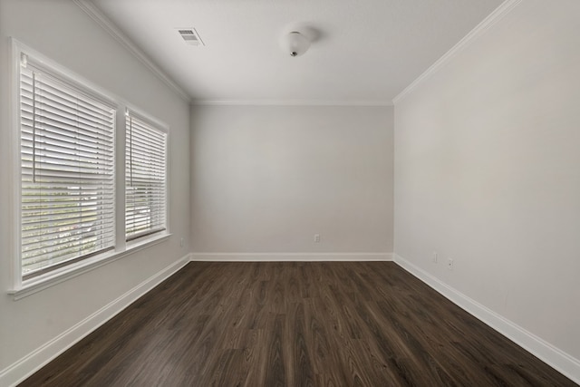 unfurnished room with ornamental molding and dark wood-type flooring