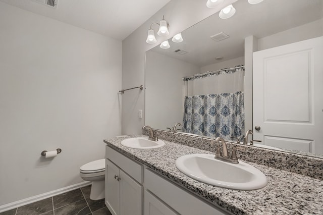 bathroom with tile patterned floors, vanity, toilet, and walk in shower