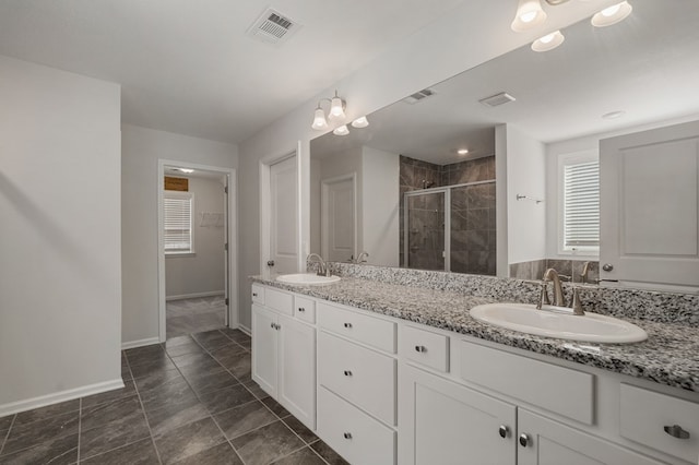 bathroom with tile patterned flooring, vanity, and a shower with shower door