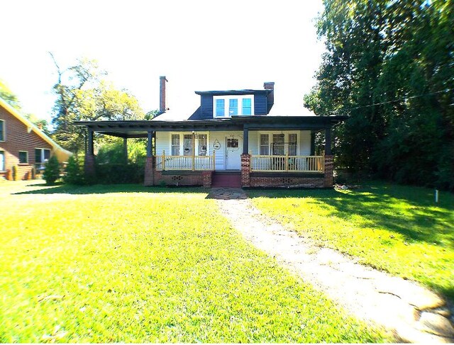 306 E Gordon St, Thomaston, GA 30286 - bungalow-style house with covered porch, a front yard, and a chimney