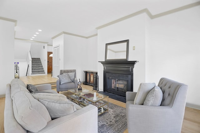 living room with light hardwood / wood-style flooring and ornamental molding