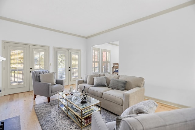 living room with hardwood / wood-style floors, ornamental molding, and french doors