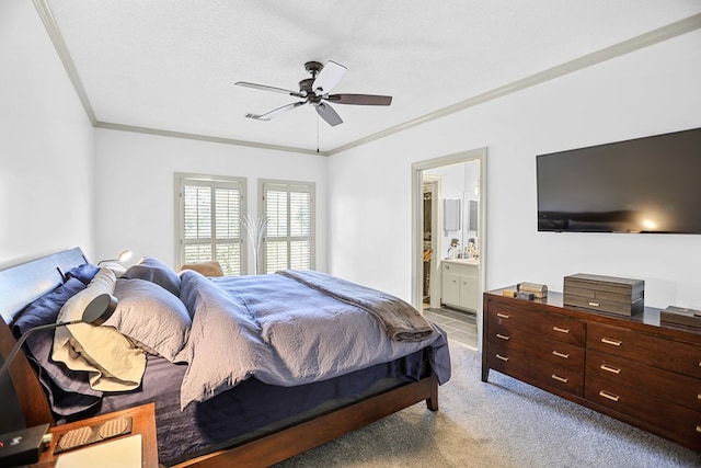 carpeted bedroom with ensuite bathroom, crown molding, ceiling fan, and a textured ceiling