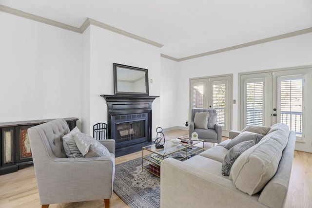 living room featuring french doors, light hardwood / wood-style flooring, and crown molding