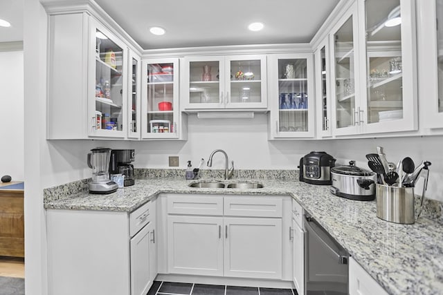 bar featuring light stone countertops, white cabinetry, stainless steel dishwasher, and sink