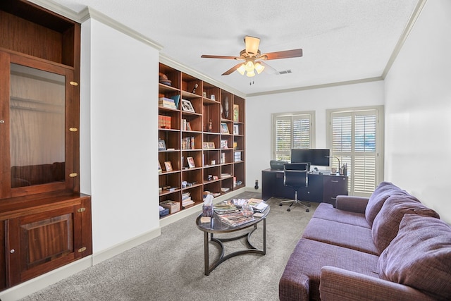 living room with a textured ceiling, carpet floors, ceiling fan, and ornamental molding