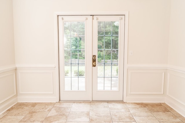 144 Lee Road 2083, Phenix City, AL 36870 - doorway to outside featuring a decorative wall, wainscoting, and light stone finish flooring