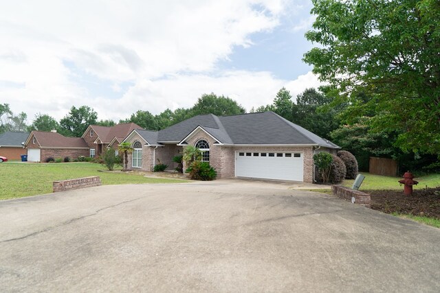 144 Lee Road 2083, Phenix City, AL 36870 - ranch-style home featuring asphalt driveway, a garage, brick siding, and a front yard