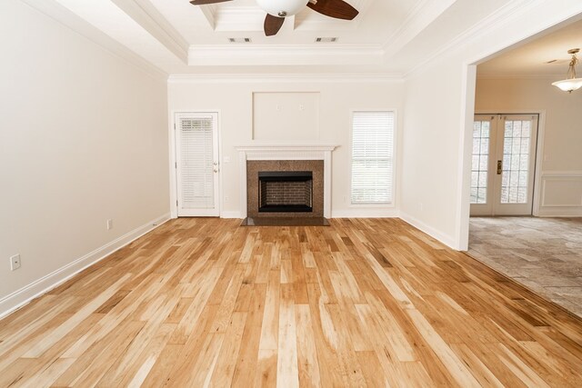 144 Lee Road 2083, Phenix City, AL 36870 - unfurnished living room featuring a raised ceiling, light wood-style flooring, crown molding, a ceiling fan, and a fireplace with flush hearth