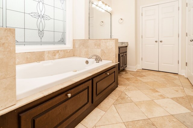 144 Lee Road 2083, Phenix City, AL 36870 - full bath with a garden tub, vanity, baseboards, and a closet