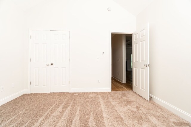 144 Lee Road 2083, Phenix City, AL 36870 - unfurnished bedroom featuring carpet floors, baseboards, vaulted ceiling, and a closet