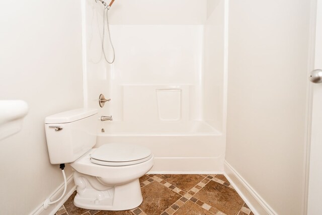 144 Lee Road 2083, Phenix City, AL 36870 - full bathroom with toilet, shower / bath combination, inlaid floor details, and baseboards