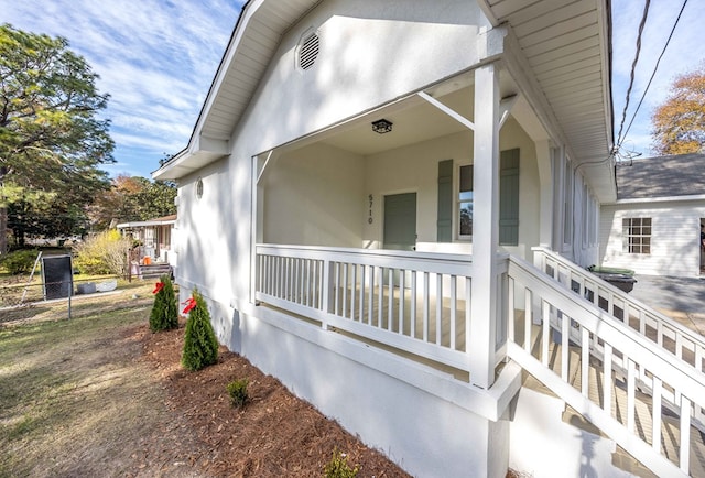 view of exterior entry with covered porch