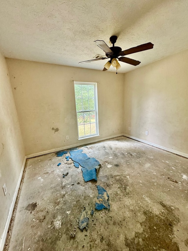 spare room featuring ceiling fan and a textured ceiling