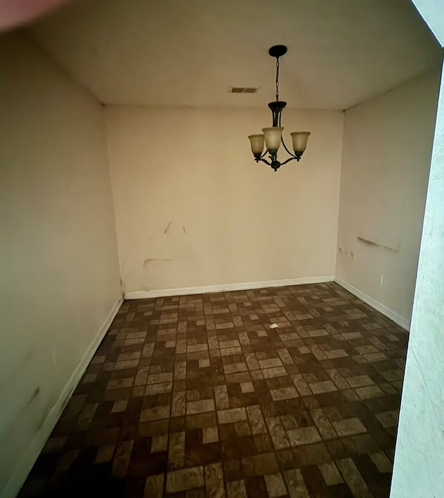 unfurnished dining area with a notable chandelier