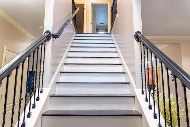 staircase featuring ornamental molding