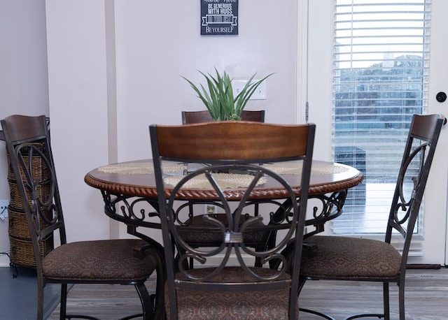 dining space with wood-type flooring and plenty of natural light