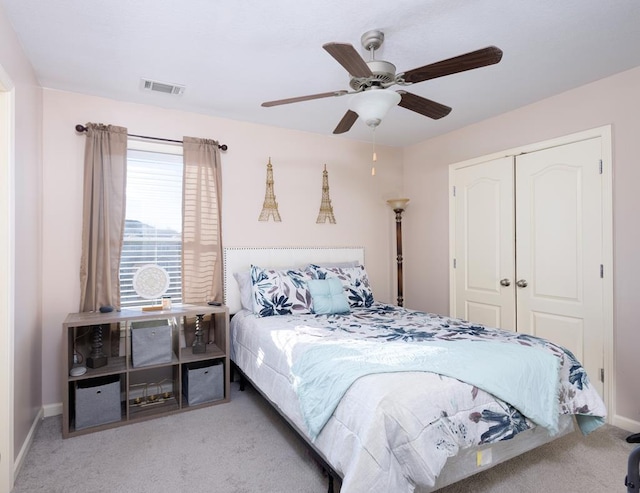 bedroom with ceiling fan, carpet, and a closet