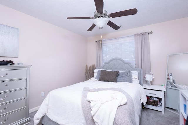 bedroom with ceiling fan and dark colored carpet