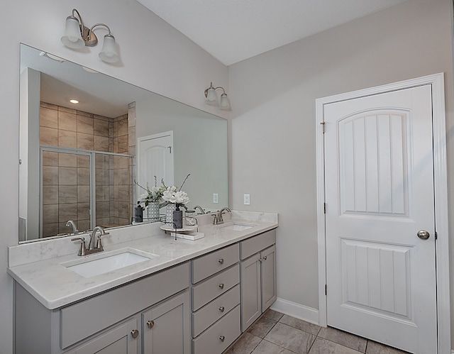 bathroom with tile patterned flooring, vanity, and an enclosed shower