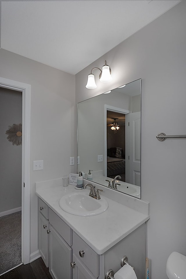 bathroom with vanity, ceiling fan, and toilet