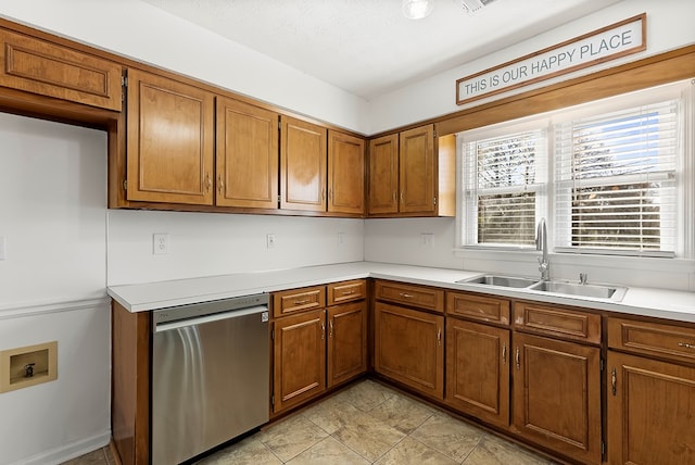 kitchen with sink, stainless steel dishwasher, and a textured ceiling