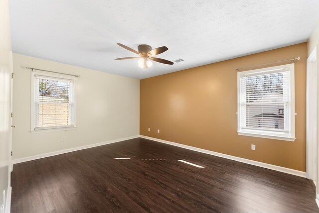 unfurnished room featuring ceiling fan, dark hardwood / wood-style floors, and a textured ceiling