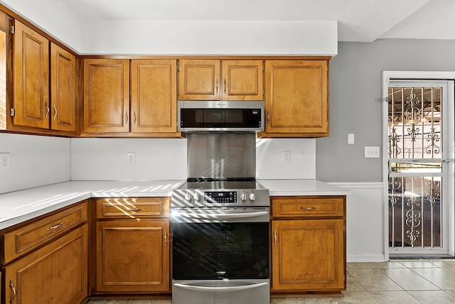 kitchen featuring light tile patterned floors and stainless steel appliances