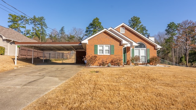 view of front of house with a carport and a front lawn