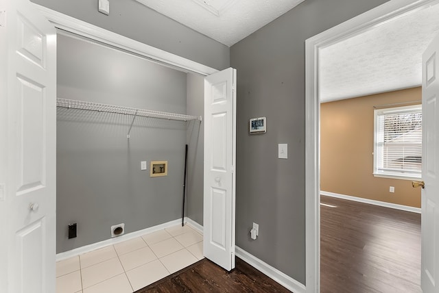 washroom with washer hookup, hardwood / wood-style floors, hookup for an electric dryer, and a textured ceiling